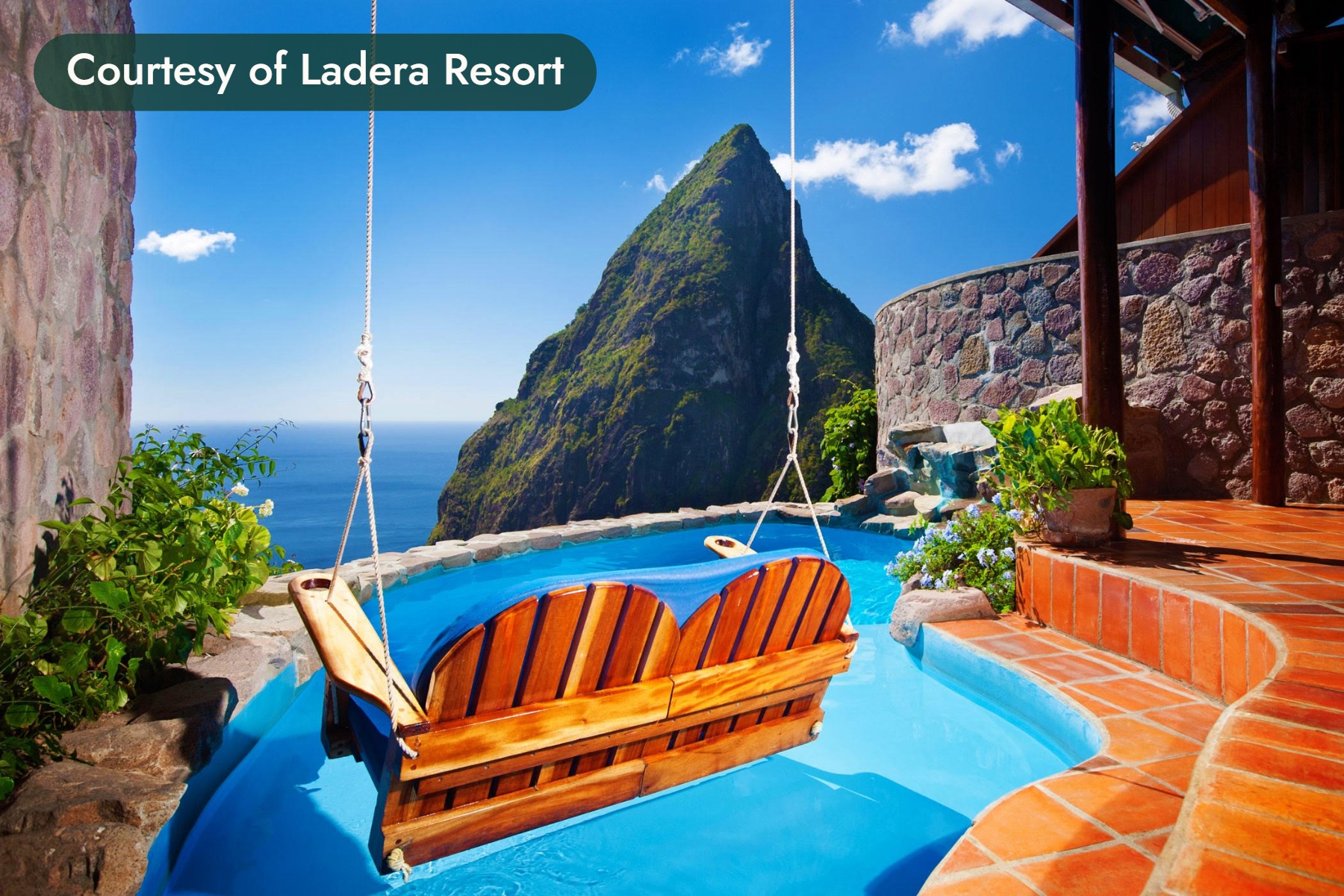 A wooden swing hangs over a plunge pool facing one of the Pitons in St. Lucia. Courtesy of Ladera Resort.