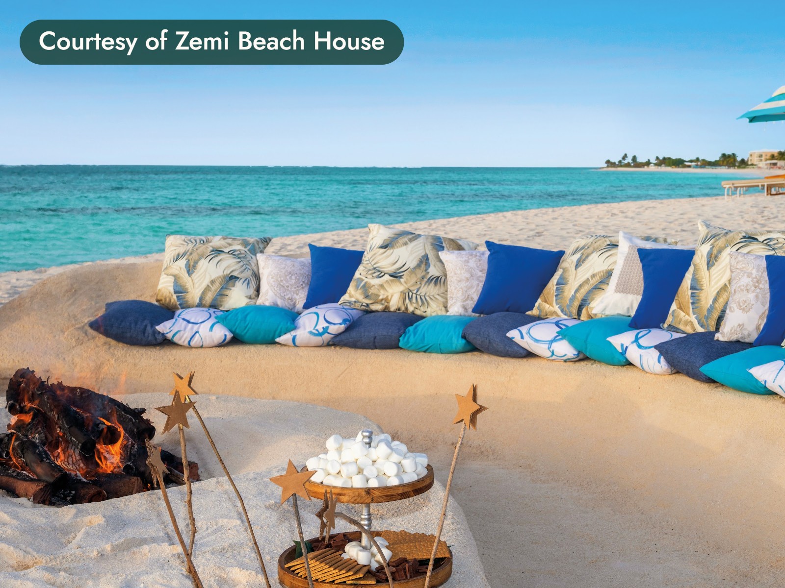 Cushioned seating around a beach fire pit in Anguilla, with marshmallows ready for s’mores. Courtesy of Zemi Beach House.